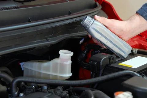 Adding brake fluid to a car Stock Photos