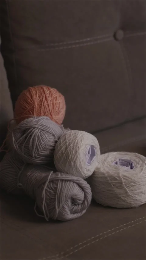Adding a bright pink yarn ball to a large wool collection vertical Stock-Footage 337451936
