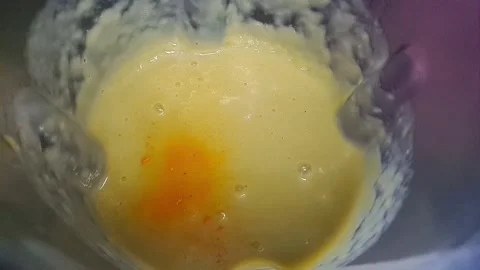 Adding Bright Yellow Food Coloring to Green Smoothie Shake in Blender Stock Footage 317010748