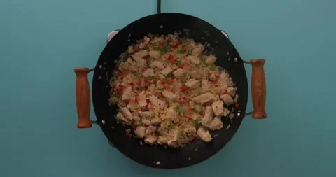 Adding broth to chicken stir fry Stock Footage 132198751