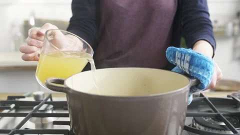 Adding broth to soup Stock Footage 140268859