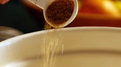 Adding brown sugar to mixing bowl, slow motion Stock Footage 49738161