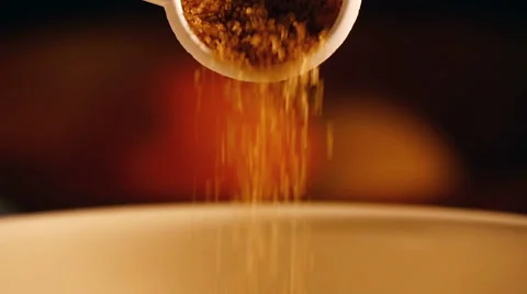 Adding brown sugar to mixing bowl, slow motion Stock Footage 49742170