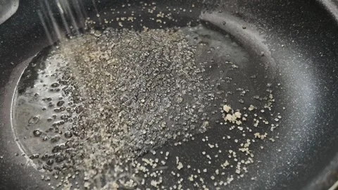 Adding brown sugar to pan for homemade caramel Stock-Footage 347016254
