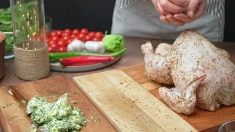 Adding butter and greens in a little pouch in a Chicken in 4K. Stock Footage 145108963