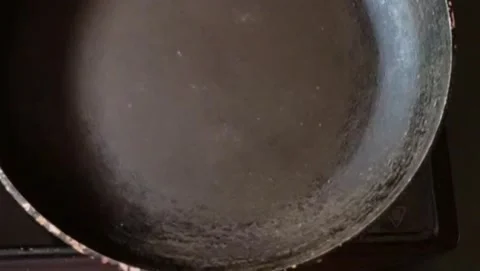 Adding butter in a frying pan. Stock Footage 201509774