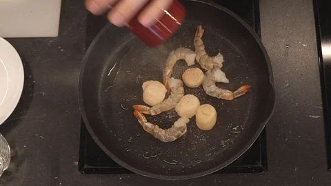 Adding butter to seafood overhead Stock Footage 112128010