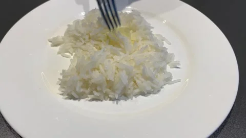 Adding Butter to Steamed Rice for Flavor Видео 343865772