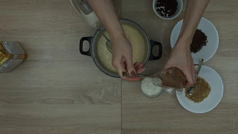 Adding Cacao to the bowl with mixture Stock Footage 87697631