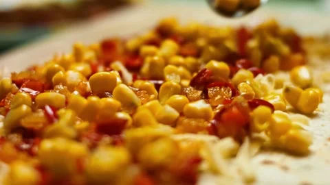 Adding canned corn to flour tortilla filled with grated cheese and vegetables Stock Footage 151293660