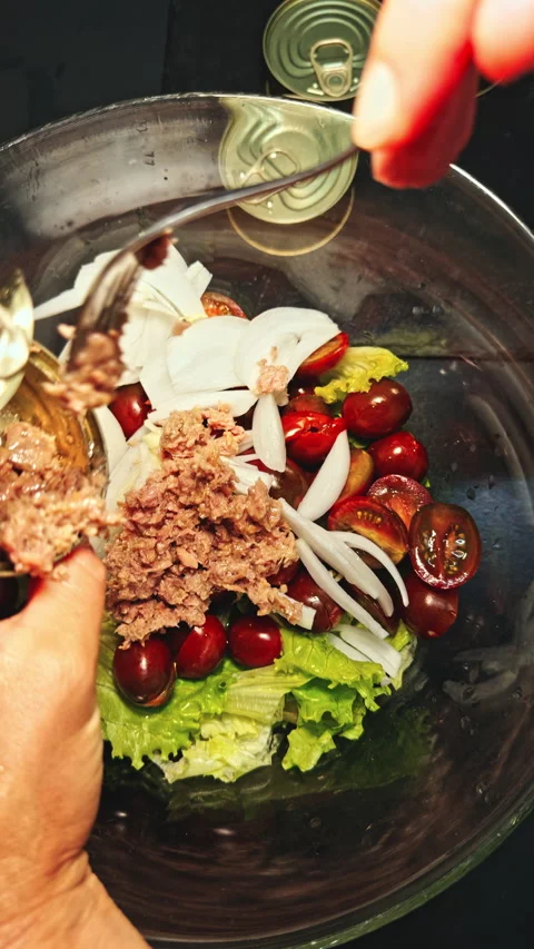 Adding canned food to salad Stock Footage 277104575