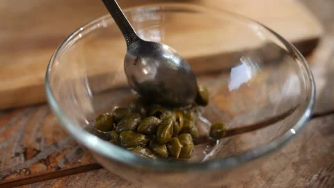 Adding Capers into Small Bowl, HD Stock Footage 148190230