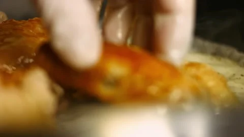Adding carved big oven roasted chicken to spiced sauce in a frying pan. Process Stock Footage 151430581