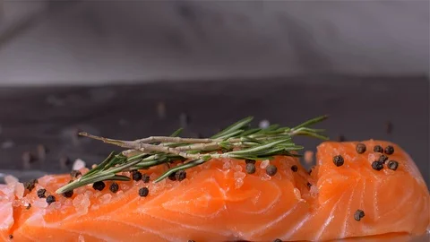 Adding celery to fish salmon. Slow motion Stock Footage 105130834