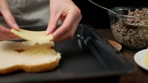 Adding cheese on bread rolls in slow motion. Stock Footage 135462575