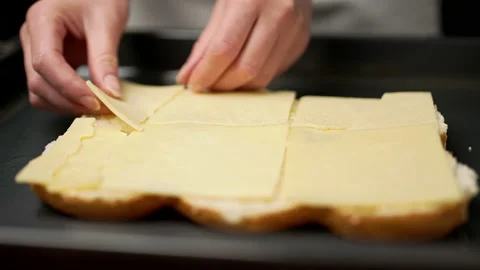 Adding cheese on bread rolls in slow motion. Stock Footage 135463003