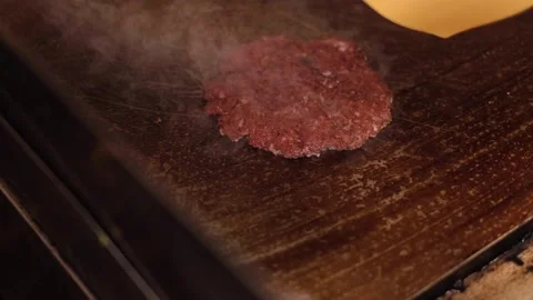 Adding cheese to cooking burger Stock Footage 133201276