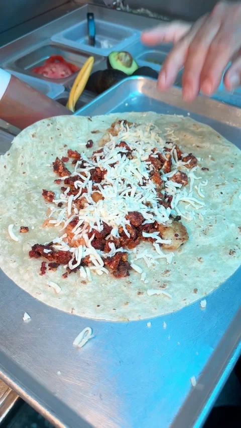 Adding Cheese to Grilled Chicken on Tortilla Stock Footage 318749285