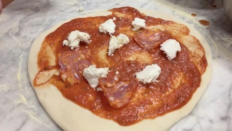 Adding Cheese, Pepperoni, and Black Olives to Pizza - Timelapse Stock Footage 339302390