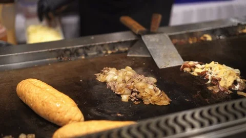 Adding cheese in Philly's cheesesteak sandwich at festiva Stock Footage 112293857