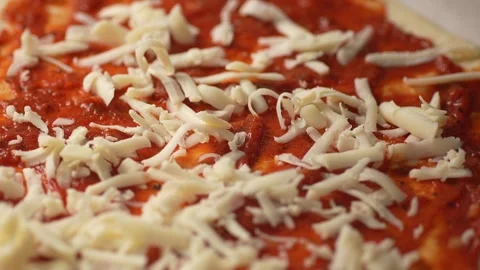 Adding Cheese to Tomato Sauce Pizza Base. Stock Footage 263364758