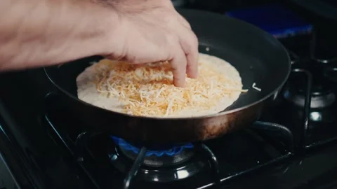 Adding cheese to a tortilla to make quesadilla 스톡 동영상 302956108