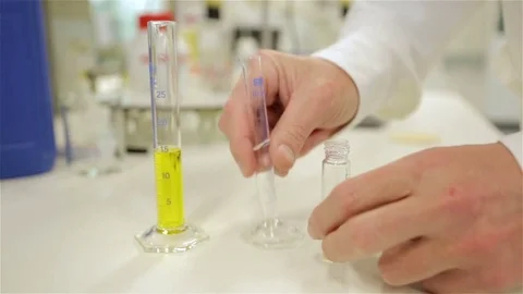 Adding a chemical to another chemical Stock Footage 82076510