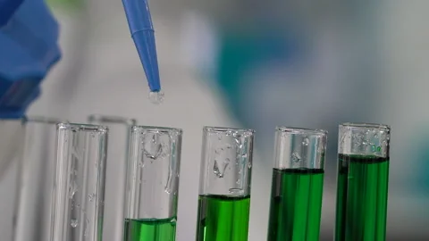 Adding chemicals into test tubes, laboratory experiment Stock Footage 148017404