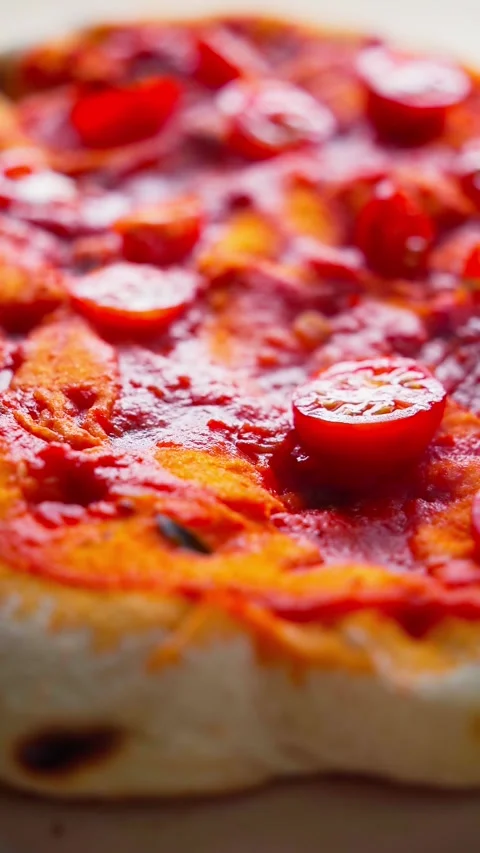 Adding cherry tomatoes on top of Pinsa Romana during preparation Stock Footage 308657520