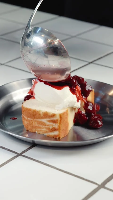 Adding Cherry Topping to Cottage Cheese Cake Slice Stock Footage 342924326