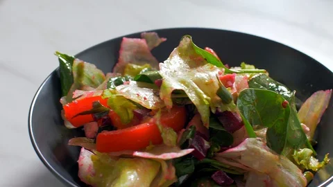 Adding chicken to a mix of salads Stock Footage 108145248