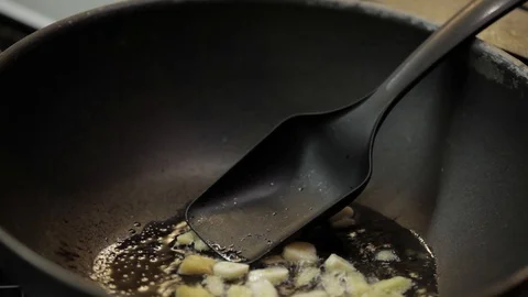 Adding chicken into wok Stock Footage 98361486