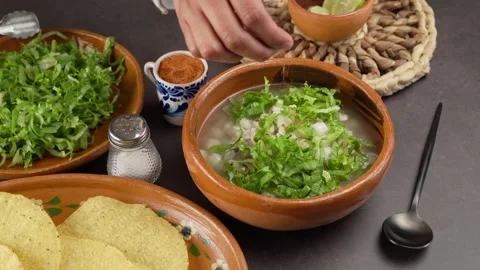 Adding chili powder to pozole, September holidays in Mexico Stock Footage 279210983