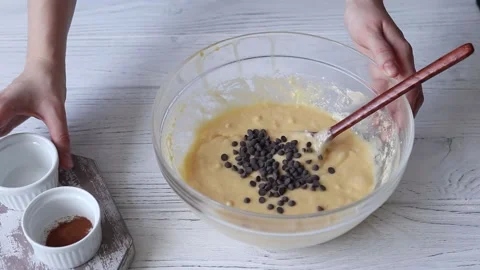 Adding chocolate and cinnamon powder to muffin batter Stock Footage 151512244