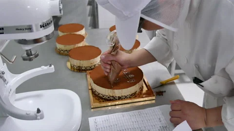 Adding Chocolate Chinese Characters to Cake Stock Footage 51455876