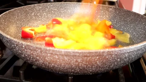 Adding Chopped Bell Peppers To A Frying Pan 스톡 동영상 138043776