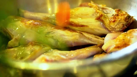 Adding chopped carrots and onions to frying rabbit meat Video stock 333835343