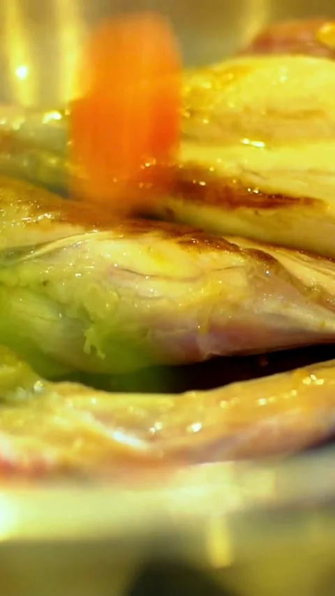 Adding chopped carrots and onions to the raw chicken Video stock 334184308