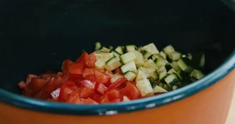 Adding chopped cucumber to a Tabbouleh salad Stock Footage 119846275