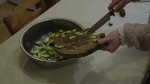 Adding Chopped Cucumbers Into Bowl During Home Cooking Preparation Stock Footage 341765651