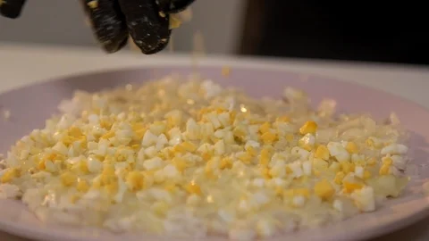 Adding chopped egg layer to puff salad Stock Footage 121364278