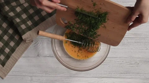 Adding chopped herbs to an omelette recipe step by step Stock Footage 150812467
