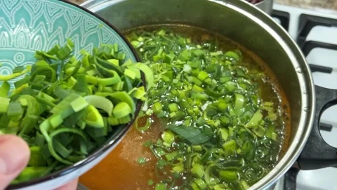 Adding chopped leek stems to a pot. The process of making Ukrainian borscht. Stock Footage 302754254