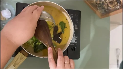 Adding Chopped Scallions and Onions into Cooking Stock Footage 312241904