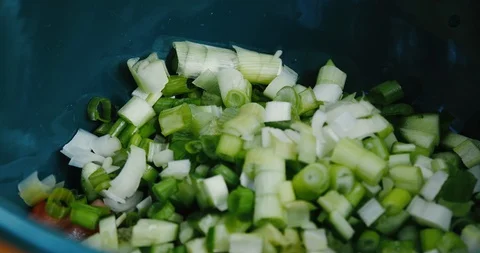 Adding chopped spring onions to tabbouleh salad Stock Footage 119845405