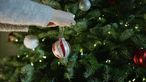 Adding Christmas Ornament to Christmas Tree in 4K Stock Footage 102585753