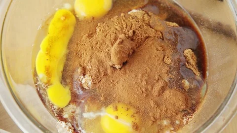Adding cinnamon and vanilla to batter Stock Footage 93001716