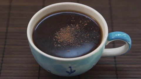 Adding cinnamon into the coffee, slow motion Stock Footage 126835569