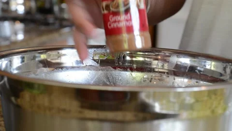 Adding Cinnamon to Mixing Bowl Stock Footage 130355094