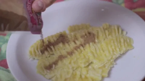 Adding cinnamon on a smashed banana Stock Footage 79537759